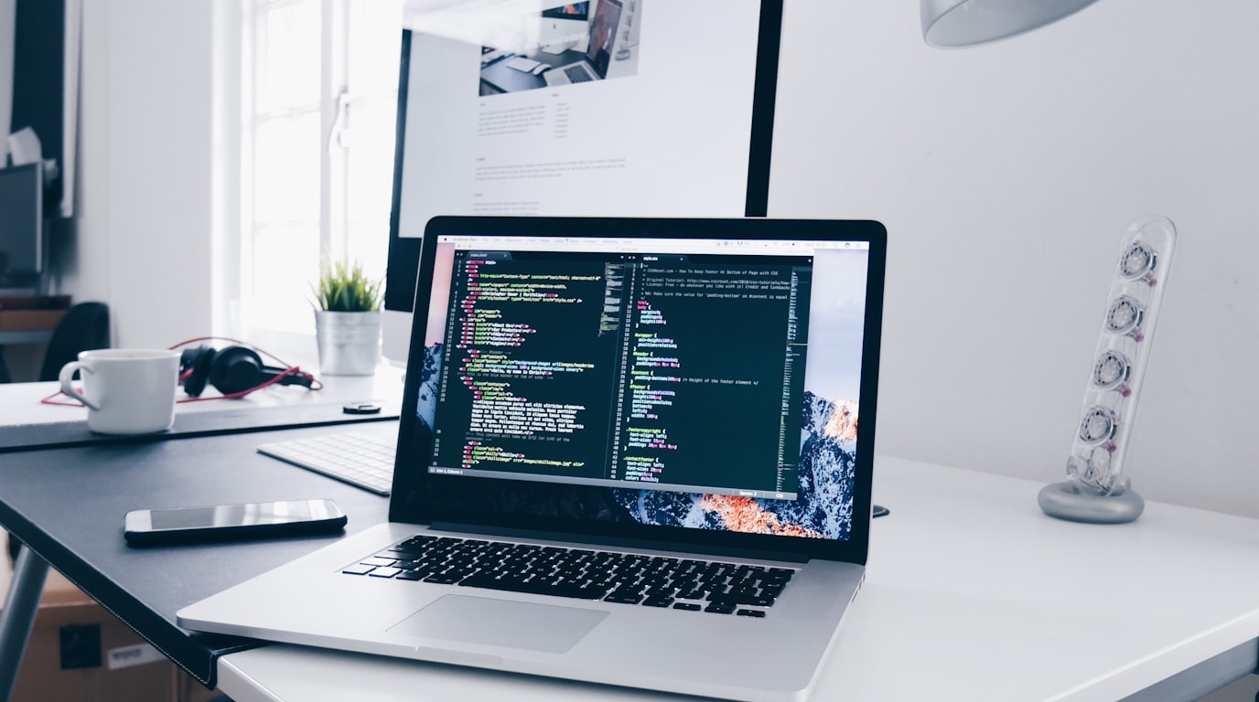 Modern desktop workstation displaying clean wireframe layouts for small business website design