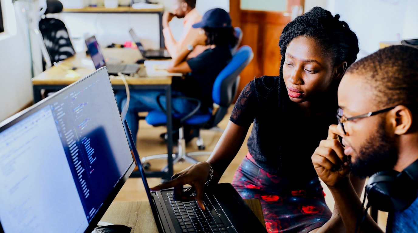 Modern small business founder planning digital service milestones in a bright creative office